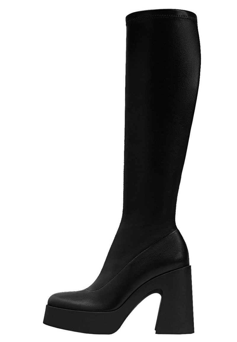 Botte noire haute, en cuir lisse, avec une semelle plateforme épaisse et un talon rectangulaire audacieux. Design élégant et ajusté.