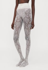 Transparente, gemusterte Strumpfhosen mit floralem Spitzenmuster in Hellgrau. Hoch geschnitten, mit einem glatten Bund und geschlossenen Zehen.