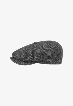 Gray herringbone wool flat cap with a rounded top, two front brims, and a small fabric button on top. Features textured, woven design.
