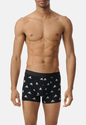 Schwarze Boxershorts mit einem wiederholten weißen Adidas-Logo-Muster. Elastischer Bund, enger Sitz, aus weichem Stoff hergestellt.