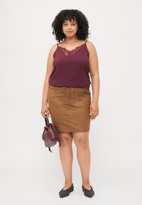 Burgundy lace-trimmed camisole paired with a brown suede pencil skirt. Accessories include a small burgundy handbag and black flats.