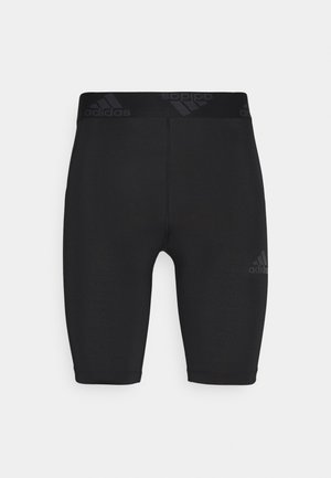 Shorts de sport Adidas noirs, ajustés, longueur genou avec taille élastique et logo discret sur la jambe et la taille.