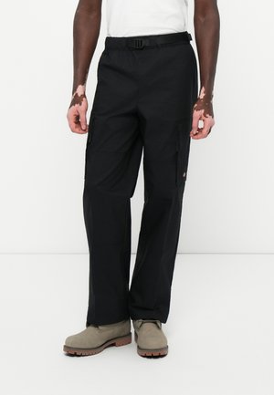 Black cargo pants with multiple pockets, made from durable fabric; features a belt at the waist and a relaxed fit design.