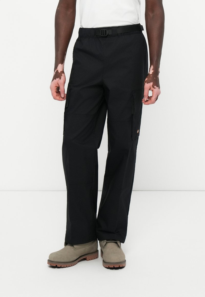 Black cargo pants with multiple pockets, made from durable fabric; features a belt at the waist and a relaxed fit design.
