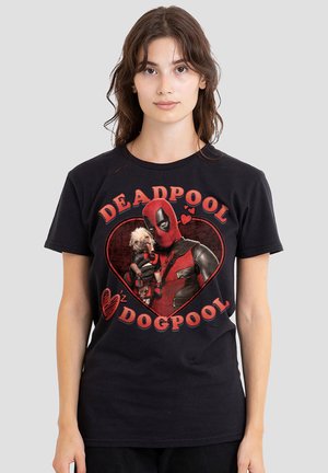 Woman wearing black t-shirt with Deadpool holding a dog inside a heart, text reads "Deadpool Dogpool" in red letters.