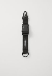 Black fabric strap featuring a plastic clip at one end and a metal ring at the opposite end. Includes a logo patch on the strap.