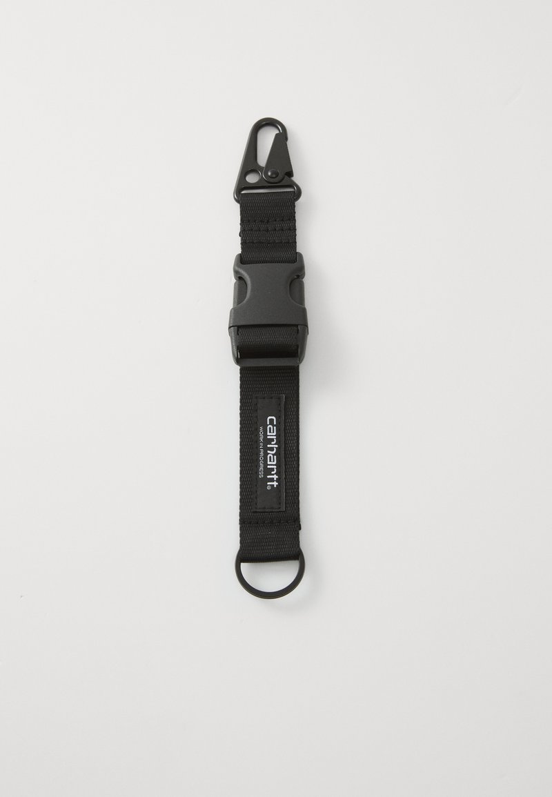 Black fabric strap featuring a plastic clip at one end and a metal ring at the opposite end. Includes a logo patch on the strap.