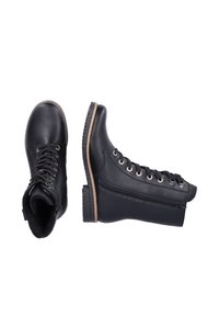 Black leather boots featuring a rounded toe, front laces, side zipper, and textured rubber soles. Natural accents on the outsole edge.