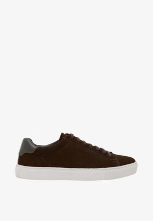 Zapatilla baja de ante marrón con parche de cuero oscuro en el talón, cordones marrones y suela gruesa de goma blanca.