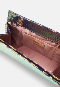 Pochette recouverte de sequins avec un intérieur en satin violet clair, une chaîne dorée et une petite poche intérieure avec une étiquette de marque métallique.