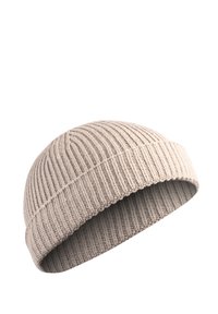Light beige knitted beanie with vertical ribbing, soft texture, and a small folded cuff on the bottom.