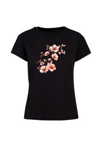 Black t-shirt made of cotton, featuring a floral design in soft pink and peach tones, with short sleeves and a crew neck.