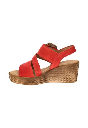 Red suede wedge sandal with crisscross straps and textured brown platform sole, open toe and back strap with elastic insert.