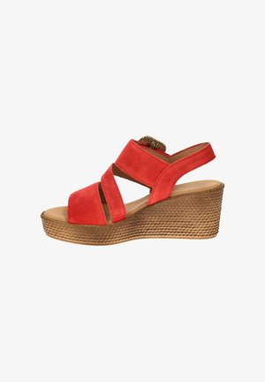 Red suede wedge sandal with crisscross straps and textured brown platform sole, open toe and back strap with elastic insert.