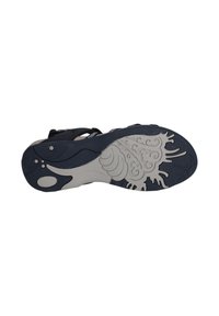 Svart sandalbotten med en grå gummiyttersula med ett vågmönster och en intrikat design. Texturerad yta och flera grepppunkter synliga.