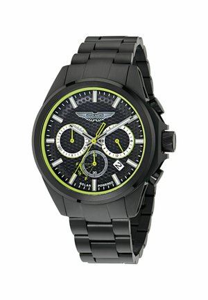 Reloj de acero inoxidable negro con esfera texturizada negra, detalles en blanco y verde, tres subesferas y visualización de fecha. Cuenta con función de energía solar.
