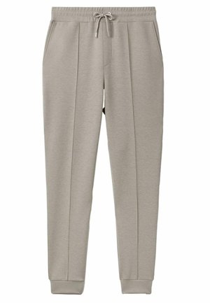 Pantaloni della tuta grigio chiaro realizzati in tessuto morbido, caratterizzati da un elastico in vita con coulisse, tasche laterali e polsini a costine.