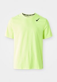 Neon zielona koszulka sportowa z krótkim rękawem, wykonana z teksturowanej, oddychającej tkaniny. Na górnej lewej części klatki piersiowej znajduje się czarne logo Nike w kształcie łyżwy.