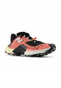 New Balance Minimus trail running shoe, featuring a pink mesh upper, black accents, textured toe cap, and a multi-patterned black outsole.