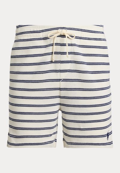Csíkos fürdőnadrág krémszínben és tengerészkékben, szövött textúrával, húzózsinóros derékrésszel és egy kis logóval az alsó szegélyen.