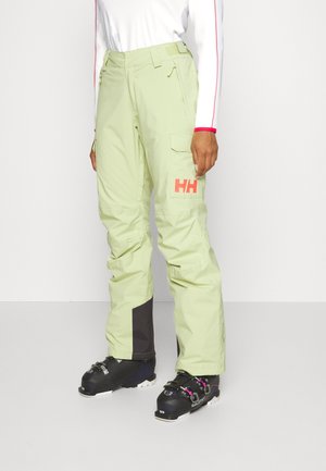 Light green ski pants with a cargo pocket, black paneling, and a pink logo. Made from durable, weather-resistant material.