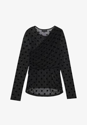 Haut noir à manches longues en tissu transparent avec des pois en velours noir, présentant un design drapé et une taille froncée pour un ajustement structuré.