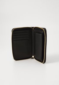 Black leather wallet with gold zipper, featuring multiple card slots and a compartment for cash or coins. Smooth texture and minimalist design.
