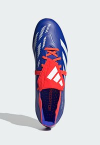Scarpa da calcio blu con strisce bianche, lacci rossi e un audace accento rosso sulla parte superiore. Superficie texture con fori di ventilazione all'interno.