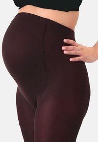Wysokiej talii burgundowe legginsy wykonane z elastycznego materiału, charakteryzujące się gładką, dopasowaną sylwetką i bezszwami bocznymi.