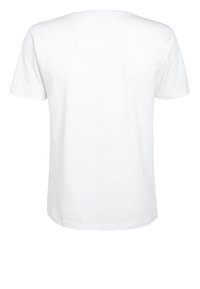 Vit t-shirt med kort ärm i bomull. Klassisk rundhalstyp med en mjuk textur. Har en standard rak fåll och inga tryck.