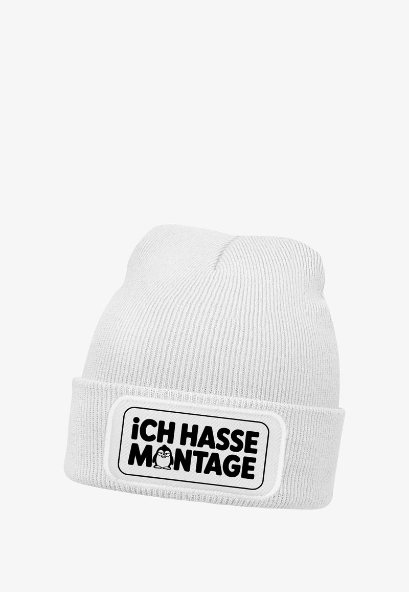 White knitted beanie with a folded cuff. Features a rectangular patch with black text "iCH HASSE MONTAGE" and an illustration of a penguin.