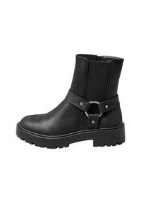 Black ankle boots with a matte finish, elastic side panels, a circular strap accent, and a chunky rubber sole with tread patterns.