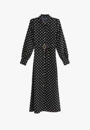Black long-sleeve button-up midi dress with white polka dots and a matching fabric belt with a gold buckle.