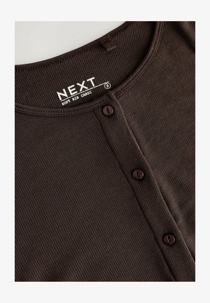 Brown ribbed cardigan with a round neckline, featuring five brown buttons and a tag labeled "NEXT" at the center. Soft texture.