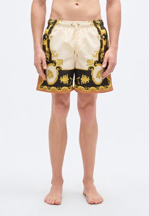 Μαγιό σορτς με ελαστική μέση, σε αποχρώσεις μπεζ και μαύρου, με χρυσαφένια διακοσμητικά σχέδια και δύο πλαϊνές τσέπες.