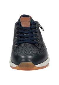 Marineblaue Sneaker mit perforiertem Lederoberteil, braunen Lederelementen, weißer Sohle, marineblauen Schnürsenkeln und seitlichem Reißverschluss für ein einfaches Anziehen.