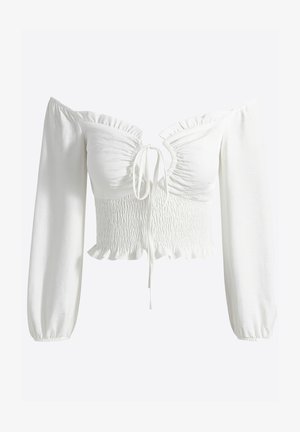 Biały krótki top z odsłoniętymi ramionami, długimi bufiastymi rękawami, marszczonym gorsetem, falbankowanym dekoltem i regulowanym wiązaniem z przodu. Gładka faktura materiału.