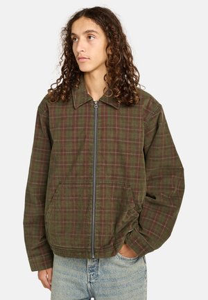 Plaid jacket in olive green and burgundy, featuring a front zipper, side pockets, and a collared neckline with a relaxed fit.