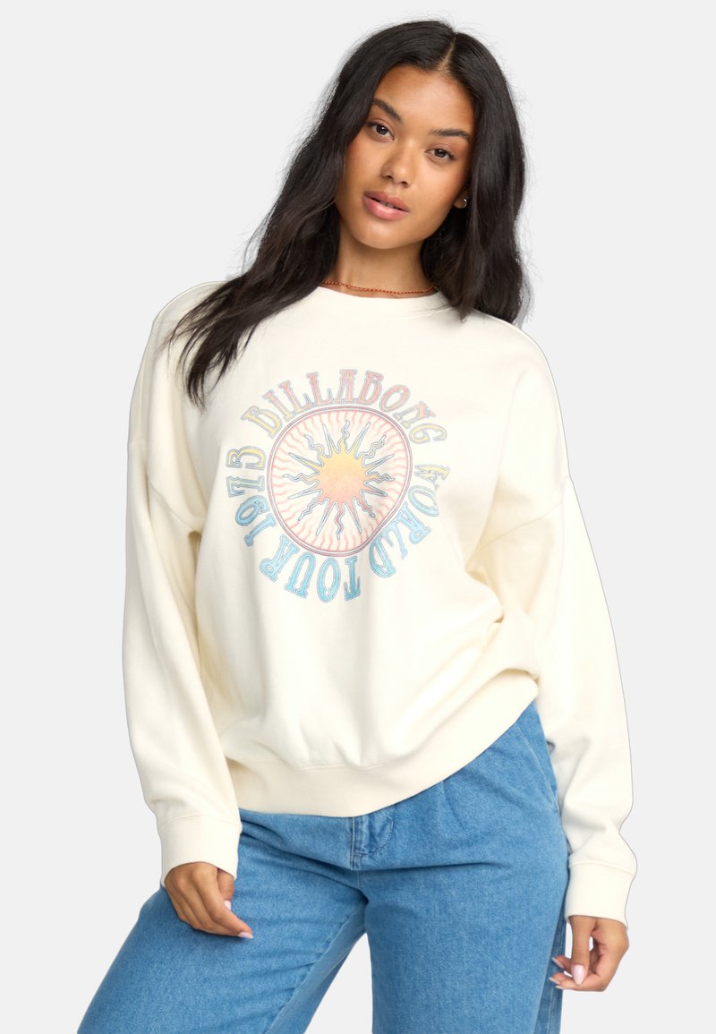Cremiges, oversized Sweatshirt mit einem kreisförmigen Sonnenmotiv und mehrfarbigen Akzenten sowie Text. Weicher Stoff mit gerippten Bündchen.