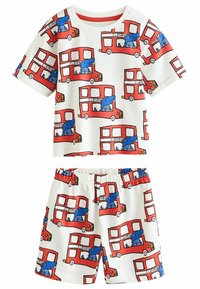 T-shirt med kort ärm i crème med tryck av en röd dubbeldäckare med tecknade djur. Mjuk tygkvalitet, elastiskt midjeband, löst sittande shorts.