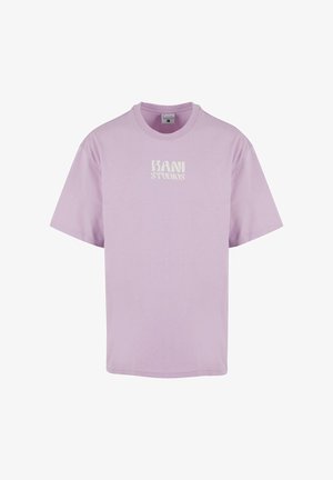 T-shirt in cotone lilla con maniche corte, scollatura rotonda e logo bianco "KANI STUDIOS" stampato sul davanti. Tessuto morbido, vestibilità ampia.