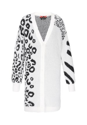 Hvid cardigan med sort dyreprint på den ene side og abstrakte sorte mønstre på den anden. Blød, fuzzy tekstur; knaplukning foran og V-hals design.