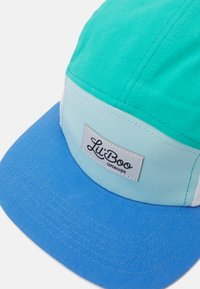 Multicolored cap featuring shades of teal and light blue with a solid blue brim. Includes a white label reading "Lil' Boo Copenhagen." Cotton material.