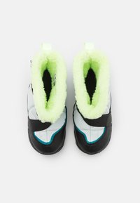 Black and white insulated boots with a soft green fleece lining. Features a Velcro strap and textured rubber outsole for grip.