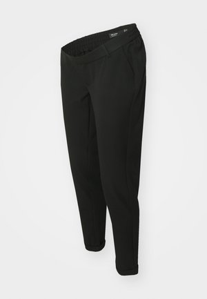 Pantalon noir fuselé avec ceinture élastique, poches latérales et ourlets retroussés, présenté sur un fond blanc uni.