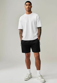 Next REGULAR FIT - Tepláky - black