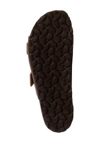 Semelle de chaussure marron avec un motif texturé de cercles entrelacés. Fabriquée en caoutchouc, avec un design large et plat pour plus de stabilité.
