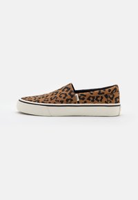 Leopardmönstrade canvas slip-on skor med en beige sula, rund tå och svarta detaljer. Lätt design som passar för avslappnad användning.