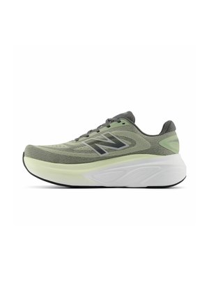 Green and black New Balance running shoe with mesh upper, thick cushioned white midsole, and black outsole, shown in side profile on white background.