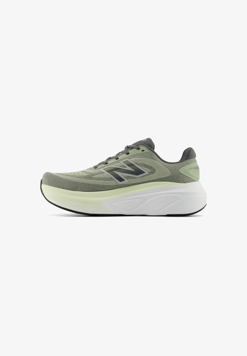 Green and black New Balance running shoe with mesh upper, thick cushioned white midsole, and black outsole, shown in side profile on white background.